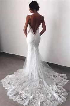 a woman in a white wedding dress looking back