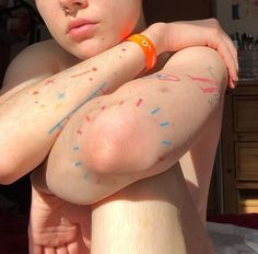 a young boy with sprinkles on his arm