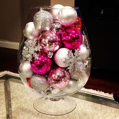 a wine glass filled with ornaments on top of a counter