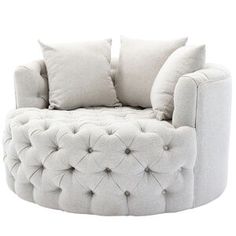 a white chair with some pillows on it