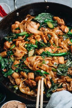 stir fry with chicken and spinach in a wok