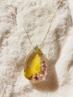 Resin tear drop pendant with amethyst and citrine crystal chips. Pear-shaped Amethyst Necklace As A Gift, Pear-shaped Amethyst Necklace For Gift, Gift Pear-shaped Amethyst Necklace, Gift Pear-shaped Amethyst Necklaces, Teardrop Citrine Necklace For Gift, Gift Citrine Teardrop Necklace, Gift Teardrop Pendant Drop Necklace With Natural Stones, Unique Yellow Teardrop Jewelry, Yellow Teardrop Necklace For Gifts