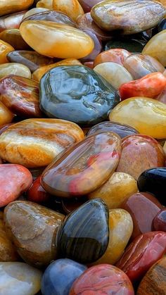 many different colored rocks together on the ground