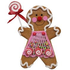 The 13 X 9 X 1 Gingerbread Ornament (model 85390BN) is designed with a cheerful expression, featuring icing-decorated hair and details. This brown ornament sports a pink apron adorned with colorful sprinkles and clutches a striped lollipop tied with a red ribbon, making it perfect for holiday decor. Swirl Lollipop, Pink Gingerbread, Swirl Lollipops, Whimsical Wreaths, Gingerbread Ornaments, Wreath Making Supplies, Summer Christmas, Pink Cheeks, Gingerbread Girl