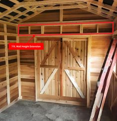 the inside of a barn with an open door