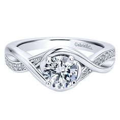 a white gold engagement ring with diamonds on the band and a center stone in the middle