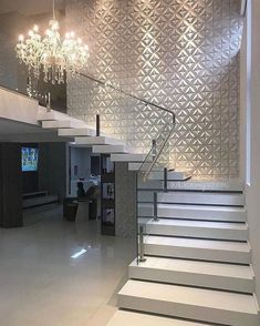 an interior with white stairs and chandelier