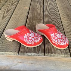 Nwot. Authentic Red Clogs Handmade In Hungary By A Hungarian Cobbler/Artist Who Runs A Small Shop, M & D Shoes. Imported By Me And Sadly Too Big. All Leather And Wood With Traditional Kolosca White Embroidered Motif. 2” Heel, 9 3/8” Length. True Size 7. Bought For $110.00 Usd. Will Sell To A Good Home For $65.00. Spring Red Clogs With Wooden Heel, Red Closed Toe Mules With Leather Sole, Red Mules With Rubber Sole For Spring, Traditional Closed Toe Clogs With Leather Sole, Traditional Closed Toe Clogs, Red Closed Toe Clogs With Wooden Heel, Traditional Slip-on Clogs With Rubber Sole, Traditional Leather Clogs For Spring, Red Clogs With Wooden Heel And Round Toe