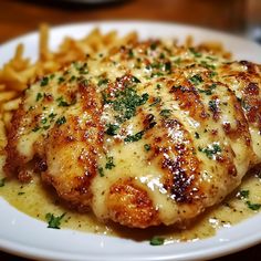 a white plate topped with chicken and french fries