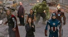 the avengers movie is being shown in this scene with many people dressed as superheros