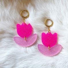 The flower power is strong with these Hot Pink Judy Earrings! These playful, pink petals are sure to add a striking pop of color to your look. Whether you are color blocking or simply playing with your look, these earrings are a must-have in our book. We rhymed! You can never have enough pink, darling. This style of earrings would serve as an excellent focal point of your look. They are certain to elevate an entrance wherever you go. You could wear your hair up or down and all eyes are sure to l Pink Flower Drop Earrings, Handmade Pink Flower Drop Earrings, Pink Dangle Earrings With Flower Charm, Pink Dangle Flower Charm Earrings, Trendy Pink Flower Earrings, Playful Pink Earrings For Party, Trendy Pink Flower Drop Earrings, Pink Flower Shaped Single Earring, Pink Flower Charm Drop Earrings