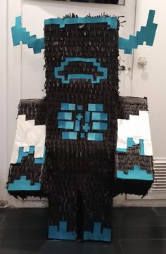 a paper mache made to look like a monster with blue and black squares on it