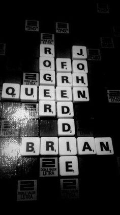 scrabble tiles spelling out the names of different cities in black and white photo