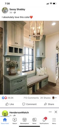 an instagramted photo of a kitchen with green cabinets and a bench in the middle