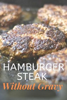 hamburger steak with gravy cooking in a skillet