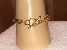 "This bright, beguiling LINK BRACELET measures 7 1/2\" long and closes with a clean-line gold-filled TOGGLE CLASP. Hanging from the bracelet's middle is an exceptionally pretty CROSS PENDANT. The pendant measures 1 1/2\" long (not counting bail) and is 1 1/4\" wide. There is a very nice ribbed, cut-in design in this GOLD RHODIUM CROSS, and the cross is completely saturated with sparkling micro pave clear crystals. The middle of the cross forms a circle of micro pave crystals. A beautiful piece. Adjustable Formal Chain Bracelet With Clasp, Adjustable Chain Bracelet With Clasp For Formal Occasions, Adjustable Gold Chain Bracelet With Toggle Clasp, Formal Adjustable Chain Bracelet With Lobster Clasp, Gold Chain Bracelet With Clasp As Gift, Adjustable Formal Bracelets With Toggle Clasp, Formal Adjustable Bracelets, Pretty Cross, Crystal Cross