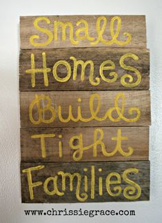 small homes build tight families painted on wood planks with chalk paint and yellow lettering