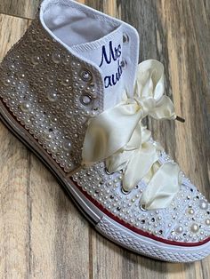 Embroidered Converse! Monochrome All WHITE Converse with white and ivory mixed pearls and rhinestones encrusted all over the shoe. ! I can do all white pearls or all ivory. (I will do the mixture if you do not specify in your order ) These shoes will sparkle and get noticed across the room! They are beautifully embroidered and hand done and each pair will be a bit different. This listing shows the I Do pattern but I can put your name or monogram on them as well as the date or Mrs. Smith. Your ch Elegant Embellished Sneakers For Wedding, Elegant Embellished White Sneakers, Elegant White Embellished Sneakers, Wedding White Embellished Sneakers, White Pearl Wedding Shoes For Bridal Shower, White Embellished Low-top Wedding Shoes, White Pearl Wedding Shoes With Round Toe, Embellished Lace-up Sneakers For Weddings, White Wedding Shoes With Pearl Embroidery