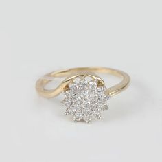 a diamond cluster ring in yellow gold