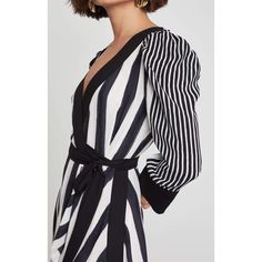 Bold mixed stripes and contrasting trim generate stand-out style in this long sleeve, faux wrap dress finished with a graceful asymmetrical hemline.PulloverSnaps and adjustable spaghetti straps - slip"Costa Stripe" printFabric Self and Contrast 1: 100% polyester satin back crepe stripe; Contrast 2: 100% polyester crepe;Lining: 91% polyester, 9% spandexMachine wash Chic Striped Long Sleeve Midi Dress, Chic Spring Dresses With Contrast Stripes, Spring Long Sleeve Dress With Striped Hem, Spring Workwear Dresses With Contrast Stripes, Striped Long Sleeve Evening Dress, Long Sleeve Dress With Striped Sleeves For Spring, Spring Dress With Striped Long Sleeves, Spring Long Sleeve Dress With Striped Sleeves, Scalloped Lace Dress