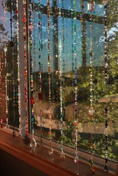 a window with beads hanging from it's side