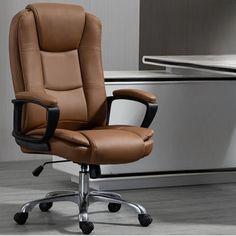 a brown office chair sitting in front of a computer desk