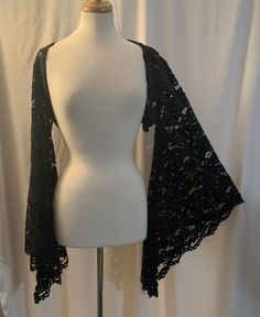 This shrug is made of black velvet flowered lace fabric. It has extra flared bell sleeves. Small fits a bust of 30" to 33".  Medium fits a bust of 33" to 36".  Small and Medium sleeves measure 17" around bicep area. Large fits a bust of 36" to 39". XLarge fits a bust of 39" to 42" .  Large and Xlarge sleeves measure 18" around bicep area. 2X fits a bust of 42" to 45". 3X fits a bust of 45" to 48".  2X and 3X sleeves measure 19" around bicep area. Sleeve length from shoulder to hem is 25". Down c Trad Goth Accessories, Forest Sprite, Witchy Style, Bday List, Witchy Goth, Trad Goth, Shrugs And Boleros