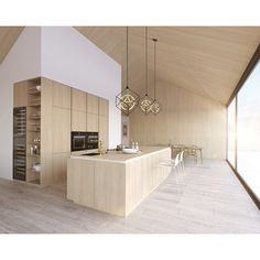 a large kitchen with wooden floors and white walls