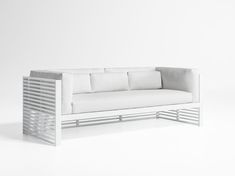 a white couch sitting on top of a white floor