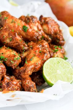 chicken wings with garnish and lime on the side, ready to be eaten