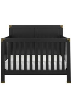 a black crib with two white sheets on the bottom and one in the middle