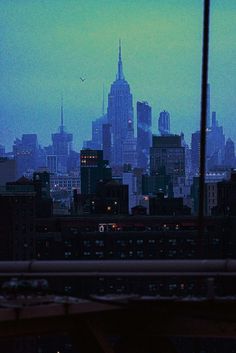 the city skyline is lit up at night, as seen from an apartment window in new york