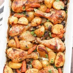 a casserole dish filled with chicken, potatoes and carrots