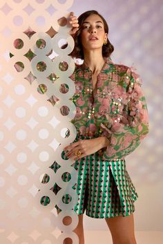 Green and pink sheer bomber jacket, hand embellished with floral appliques and geometric motifs. Comes with an inner. 
Component: 2
Pattern: Embellished
Type Of Work: Floral Appliques
Neckline: Band Collar
Sleeve Type: Puff Sleeves
Fabric: Organza
Color: Green, Pink
Other Details: 
Sheer jacket
Front zipper
Floral appliques
Note: The skirt and belt worn by the model is not for sale
Occasion: Party - Aza Fashions Spring Sequin Long Sleeve Set, Hand Embellished Long Sleeve Blouse, Spring Designer Party Sets, Designer Party Sets For Spring, Designer Long Sleeve Sets For Spring, Pink Long Sleeve Sequin Set, Spring Party Sets With Mirror Work, Spring Sets With Mirror Work And Long Sleeves, Silk Long Sleeve Blouse With Mirror Work