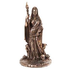 a statue of the virgin mary holding a cross