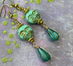 These beautiful and quirky blue/green Czech glass moons are my favorite color. I love the minty green and blue hues in these moons. They have a gold wash highlighting all their mischievous moon face details. I added teal and gold Czech glass teardrops and little gold colored beads to complement the moon faces.  Hooks are 18k gold plated brass and are nickel free. Lever backs are available upon request.  All my earrings come on a hand stamped card and are lovingly wrapped in tissue and a drawstring bag, ready to gift or keep for yourself of course!  Thank you for stopping by Laura Lingle Studio. I love ❤️ my customers!  https://www.etsy.com/shop/lauralinglestudio Unique Green Czech Glass Earrings, Whimsical Green Czech Glass Earrings, Handmade Green Whimsical Earrings, Whimsical Green Jewelry, Whimsical Green Round Jewelry, Whimsical Turquoise Nickel-free Earrings, Turquoise Jade Earrings For Gift, Whimsical Handmade Turquoise Earrings, Whimsical Green Dangle Earrings