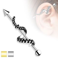 an ear piercing with black and white dots on it