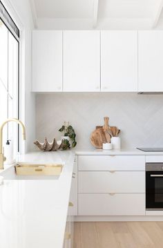 the kitchen is clean and ready for us to use it's white countertops