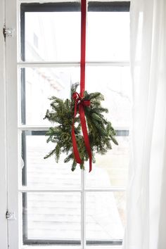 a wreath hanging from the side of a window