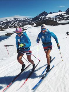 two people on skis in the snow