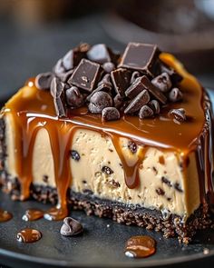 a piece of chocolate cheesecake on a plate with caramel drizzle and chocolate chips