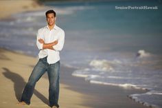 a man standing on the beach with his arms crossed