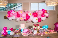 a birthday party with balloons, cake and decorations