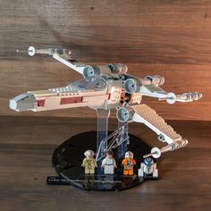 a lego star wars set is shown on a wooden surface with other toys around it