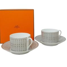 a boxed cup and saucer with an orange box