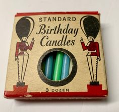 an old fashioned birthday candle box with three candles in it