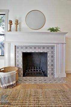 a living room with a fire place in the middle and a basket on the floor