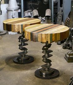 two wooden tables sitting next to each other on top of a table in a room