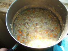 a pot filled with soup sitting on top of a stove