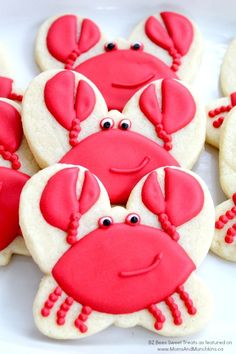 crab cookies decorated with red and white icing on a plate, ready to be eaten